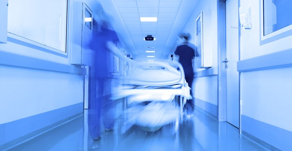 A patient is rushed down a hospital hallway