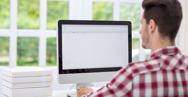 A man stares at his blank computer screen