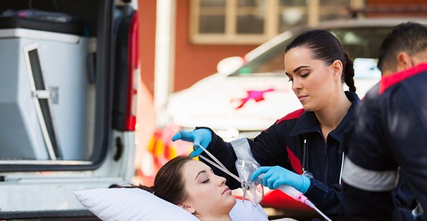 An EMT takes care of a woman on a stretcher