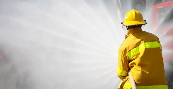 A firefighter sprays water on a fire
