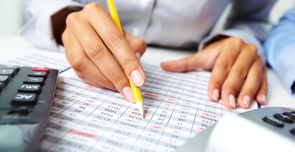 An employee marks on a spreadsheet