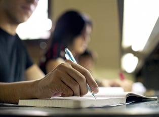 A student takes notes during class