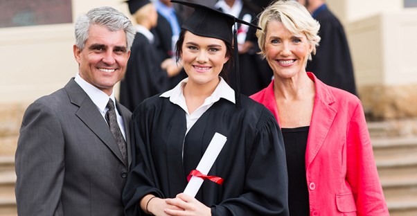 A college graduate poses for a picture with her parents