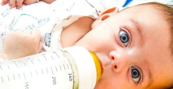 a baby eating baby formula