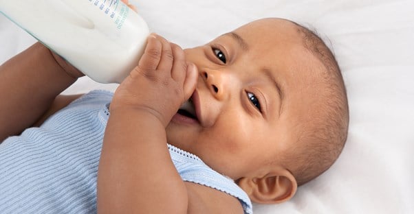 a baby drinking baby formula