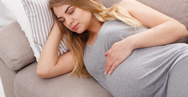 a pregnant woman trying to sleep