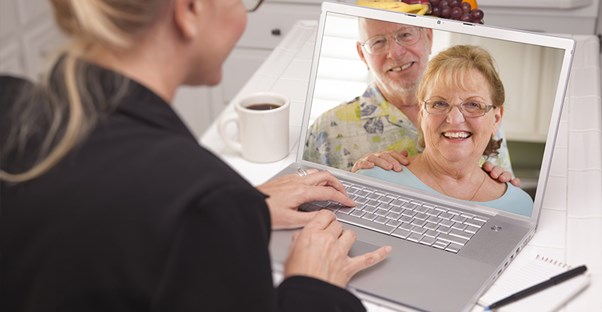 Woman chatting online with older couple