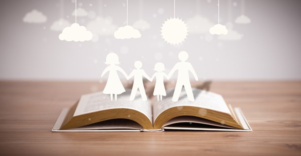 a paper family emerges from the pages of a book