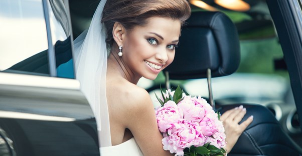 Bride smiling as she thinks about how helpful her wedding timeline was