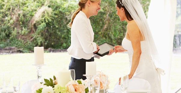 A bride goes over wedding details with a wedding planner