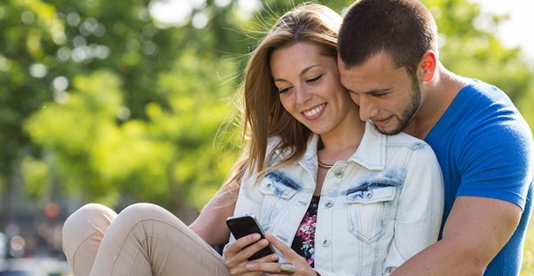 An engaged couple plans their future wedding through various wedding planning apps