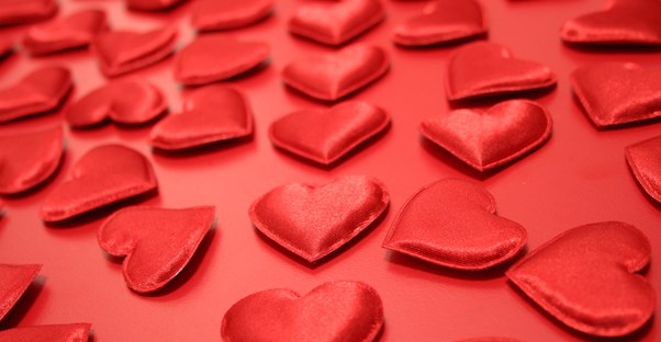 Satin hearts spread on a red background.