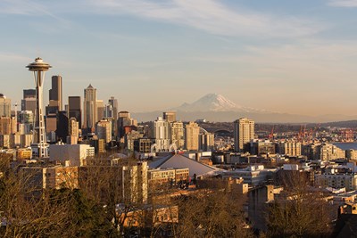 Downtown Seattle and the Space Needle are situated in front of Mount Rainier in the distance.