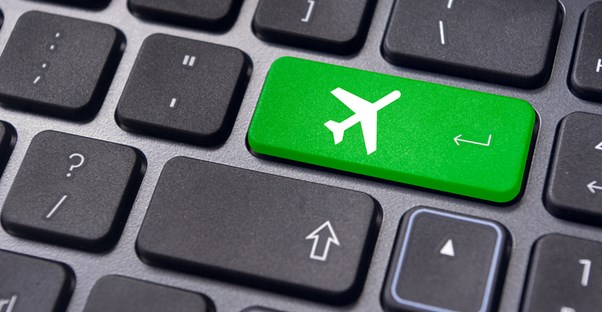 a computer keyboard with an image of a plane on a green return key
