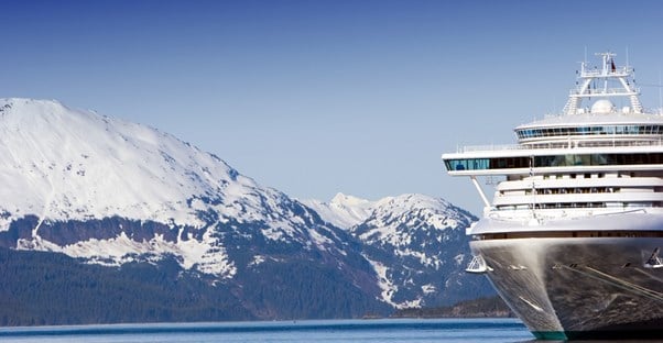 an Alaskan cruise ship sails the calm waters