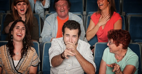 audience members laugh hysterically at a joke by a branson comedian