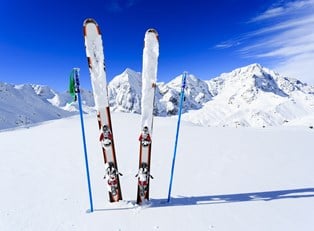a pair of skis sticks out of the snow