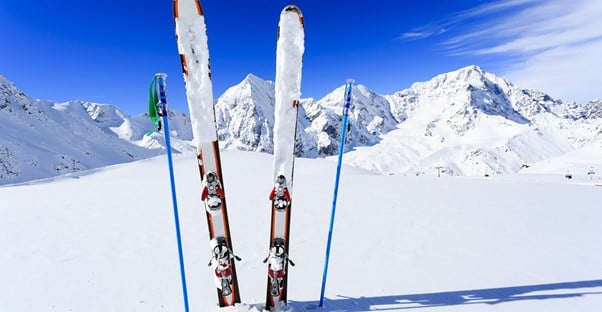 a pair of skis sticks out of the snow