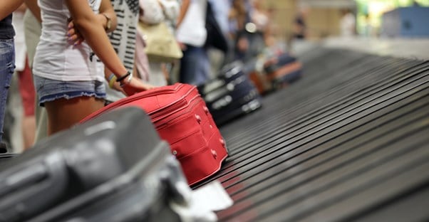 a baggage claim conveyor belt rotates various bags around for pick up