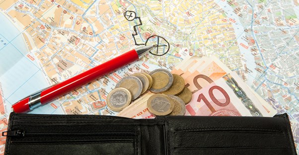a travel wallet is full of euros and coins