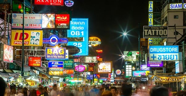 downtown Bangkok is lit up by lights and bright signs