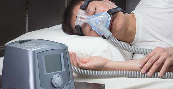 Man asleep wearing CPAP mask