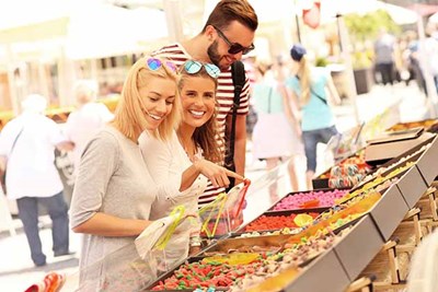 Three people at a farmers market