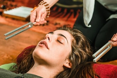 Woman trying out a holistic medicine treatment to treat her pain.