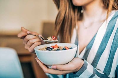 woman eating cereal