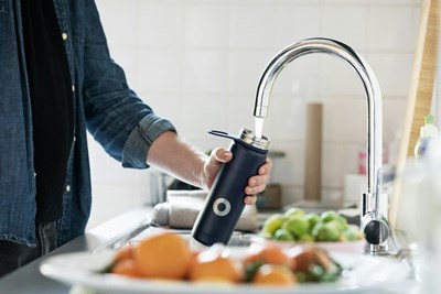 refilling a refillable bottle at the sink that may have forever chemicals