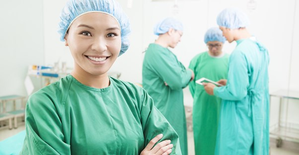 a surgeon smiling after a breast augmentation surgery