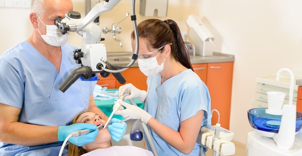 a surgeon installing a patient's braces