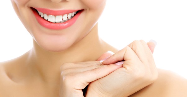 a woman who knows the five alternatives to dental veneers