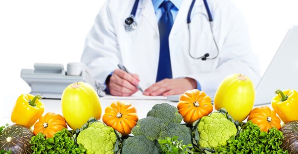 a nutritionist surrounded by fruits and vegetables