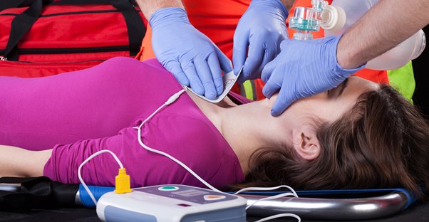 a woman using a defibrillator
