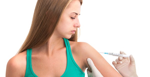 a woman gets a vaccine before studying abroad